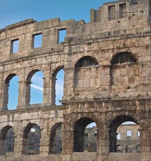 a large building with arches in front of it
