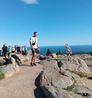 a group of people standing on top of a mountain