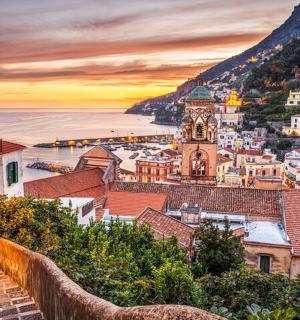 a view of the city of positano at sunset