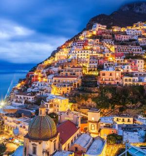 a view of positano on the amalfi coast at night