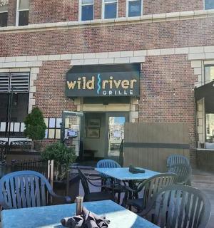 a patio with tables and chairs in front of a building