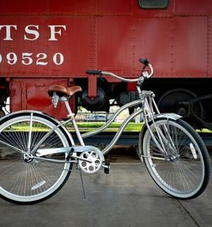 a bike parked next to a red train