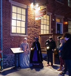 a group of people standing outside of a brick building