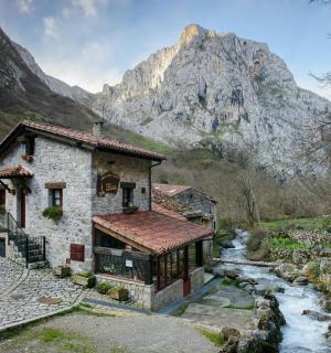 a stone building with a mountain in the background