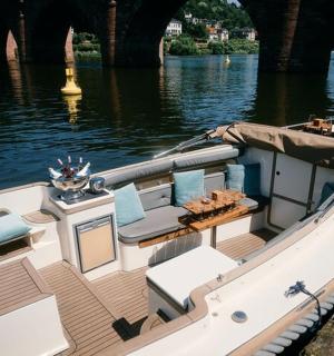 a boat is docked on the water under a bridge