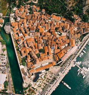 an aerial view of a city next to the water