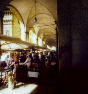 a group of people sitting at tables in a building