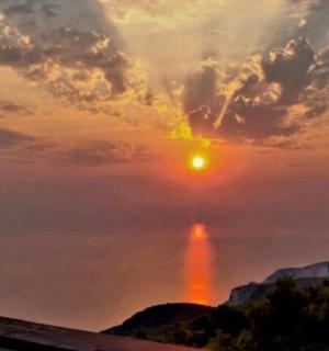 a sunset view from the balcony of a house