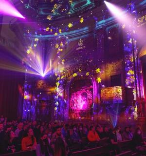 a crowd of people in a room with lights