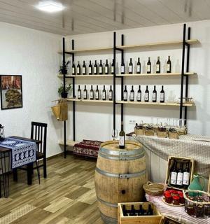 a wine tasting room with a table and wine bottles