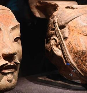 a statue of two heads next to each other