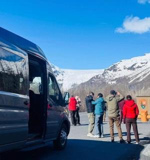 a group of people standing outside of a van
