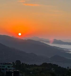 a sunset with the sun rising over the mountains