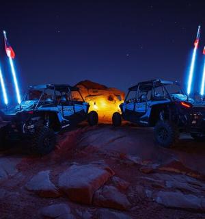 two atvs parked in the desert at night