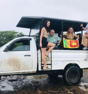 a group of people sitting in the back of a truck