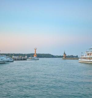 three boats are docked in the water on a river