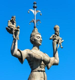 a statue of a woman with a cross on her head