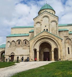 an old church with a green roof and two towers