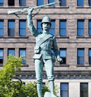 a statue of a man holding up a gun