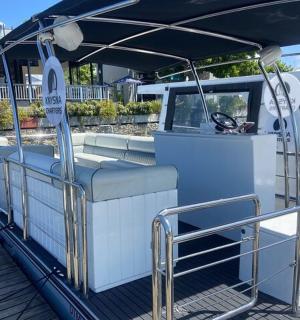 a white boat with an umbrella on the water