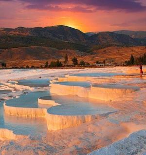 a hot spring in the desert at sunset