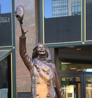 a statue of a man holding a baseball