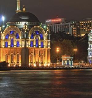 a large building with blue lights on it at night