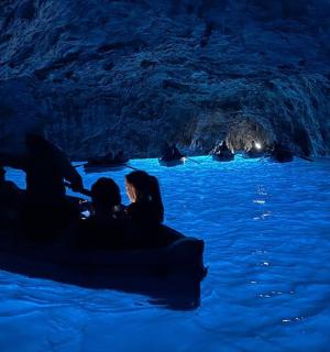 a group of people in a boat in a cave