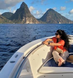 a woman sitting on the front of a boat in the water