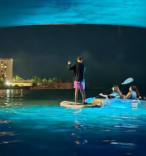 a man standing on a paddle board in the water