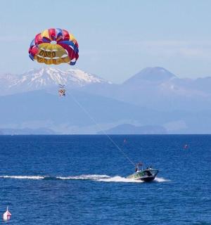 a kite flying over a boat in the water