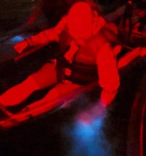 a group of people in a room with red lights