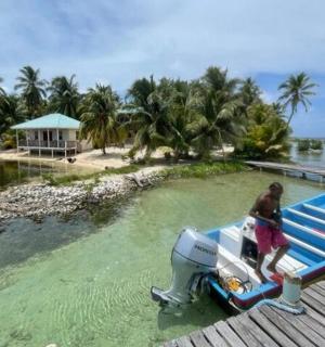 a man holding a surfboard on a boat on a dock