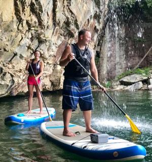 a man and a woman on paddle boards in the water