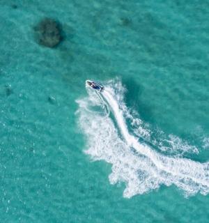 an aerial view of a boat in the ocean