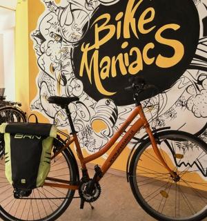 a bike parked in front of a wall with a sign