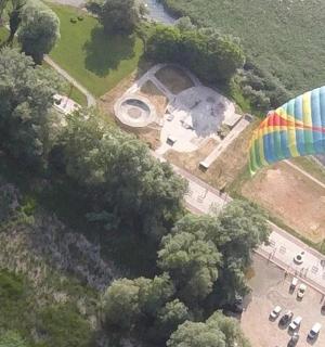 an overhead view of a large rainbow parachute