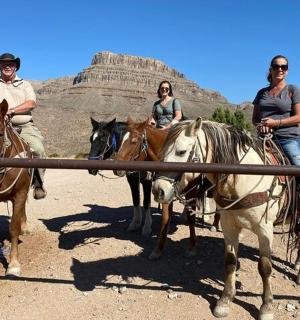 a group of people riding horses in the desert