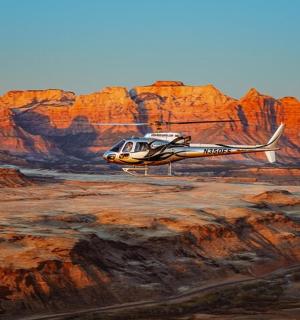 a helicopter is flying over the desert