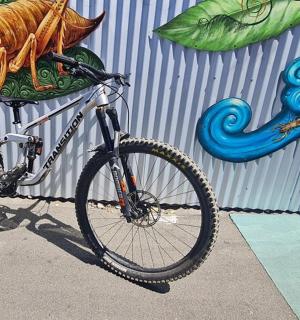 a bike parked in front of a wall with a mural