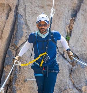 a man is climbing a rock wall
