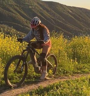 a person riding a bike on a dirt road