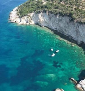 an aerial view of a cove with boats in the water