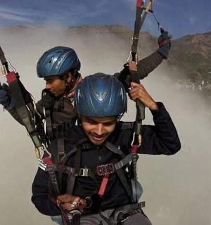 two people are zip lining in the mountains