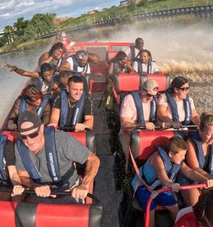 a group of people riding on a boat on a river