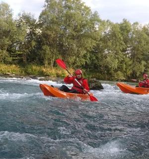 dva lidé jsou v kajacích na řece