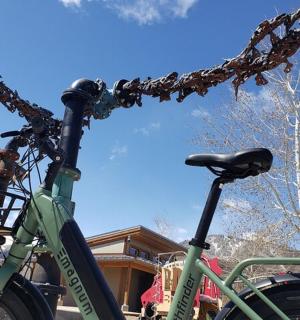 a green bike parked next to a house