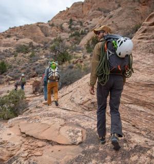 a man with a backpack walking on a mountain