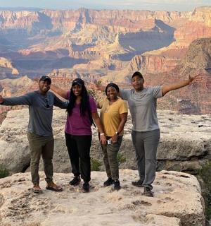 a group of people standing on the edge of the grand canyon