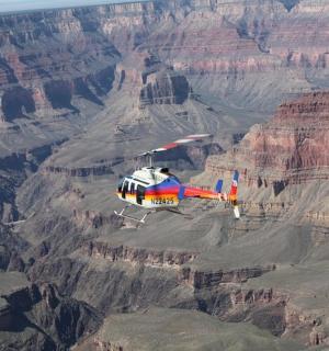a helicopter is flying over the grand canyon